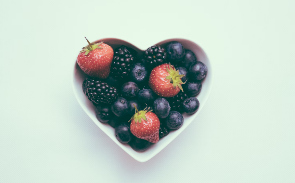 a heart-shaped bowl of fruit