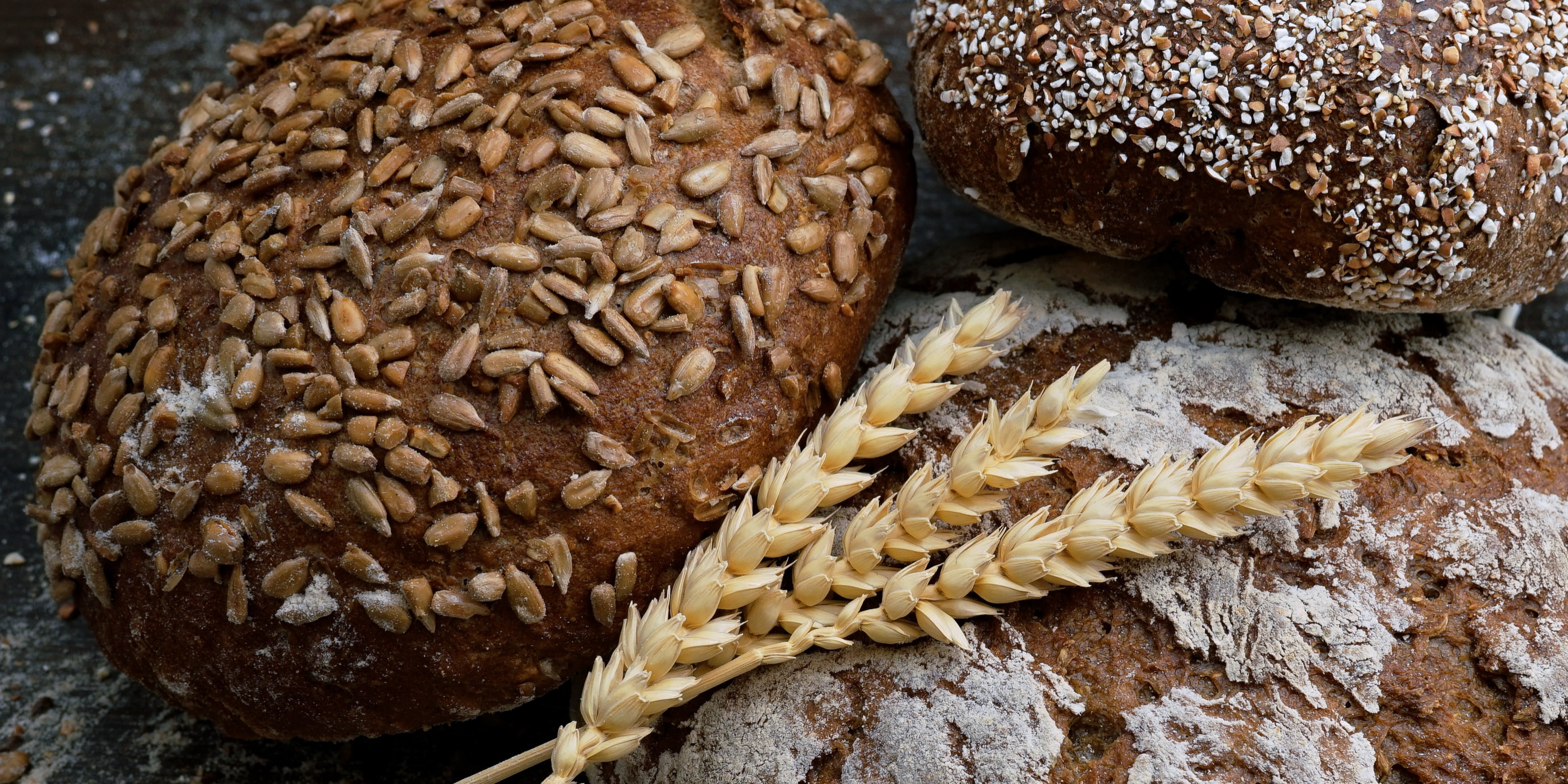 three loafs if bread and wheat