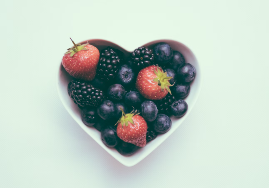 a heart-shaped bowl of fruit