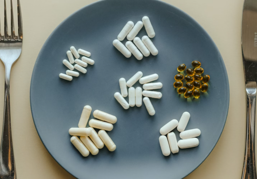 plate with piles of supplement pills